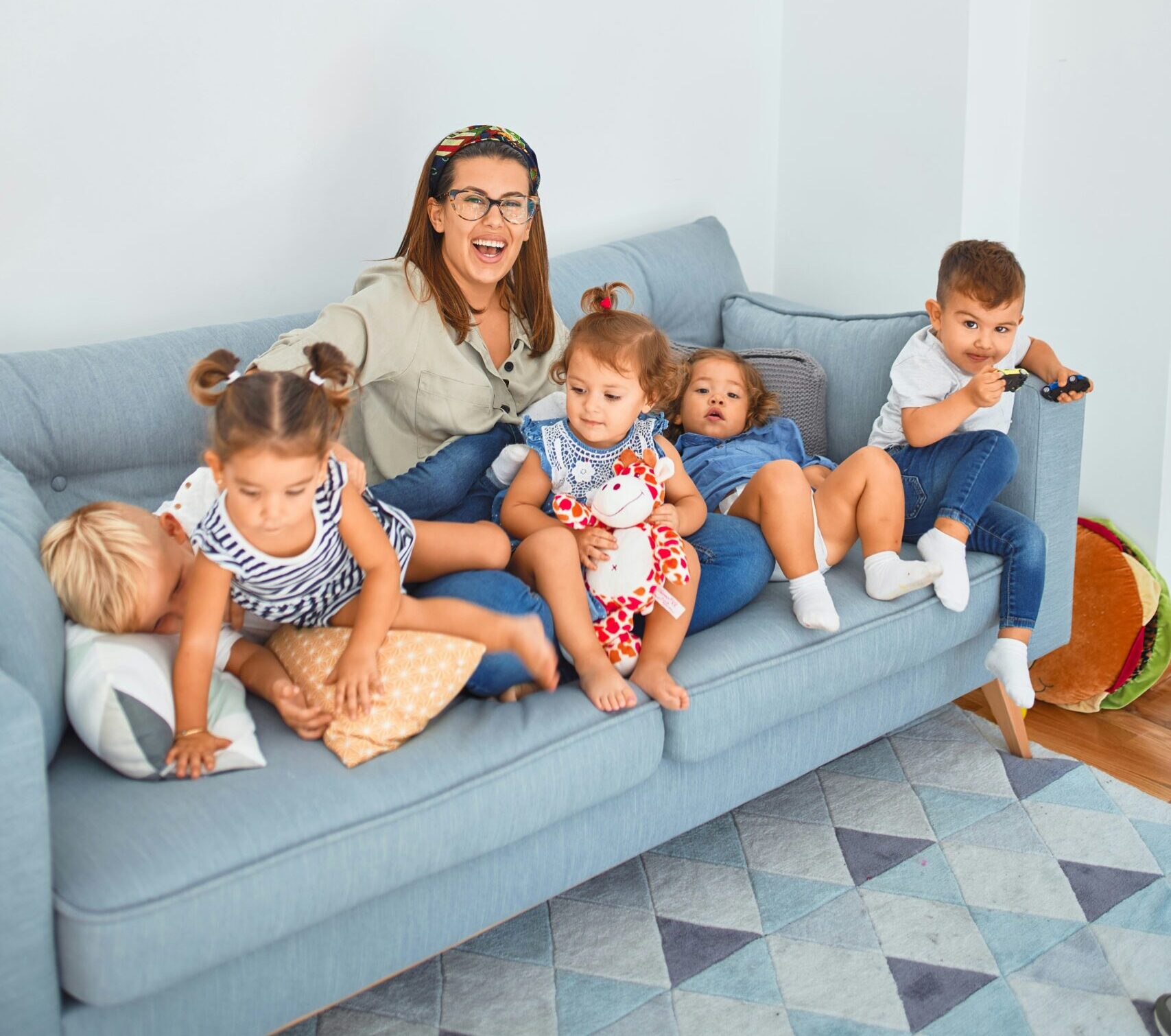 3 women sitting on gray couch